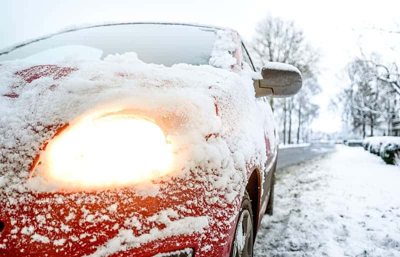 red-car-covered-with-snow-during-daytime