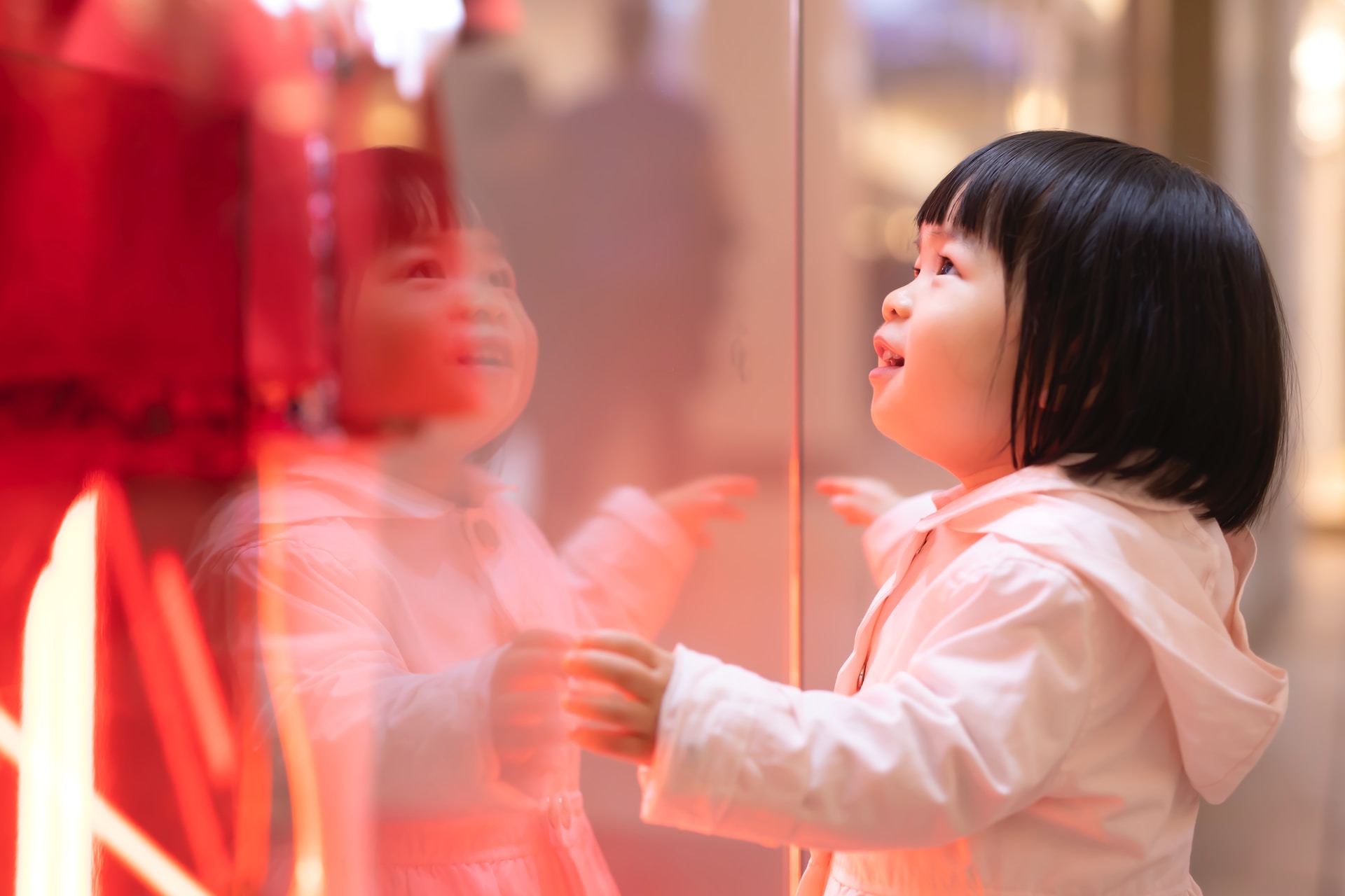 Girl watching store window at a mall