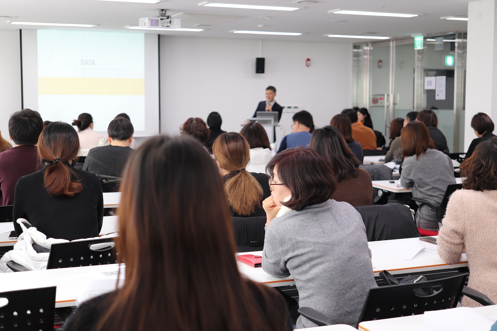 Students in classroom at college doing a test