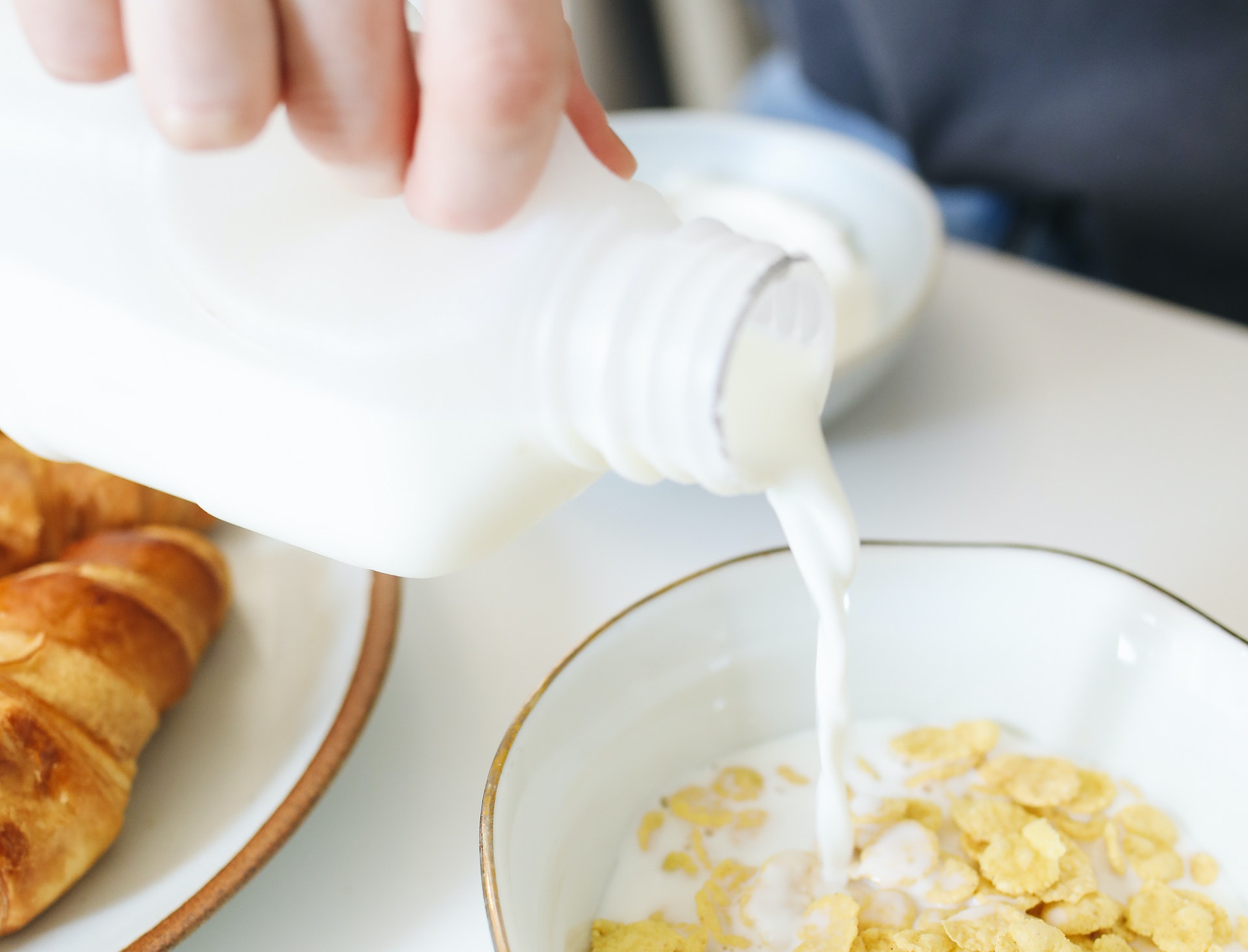 person pouring milk