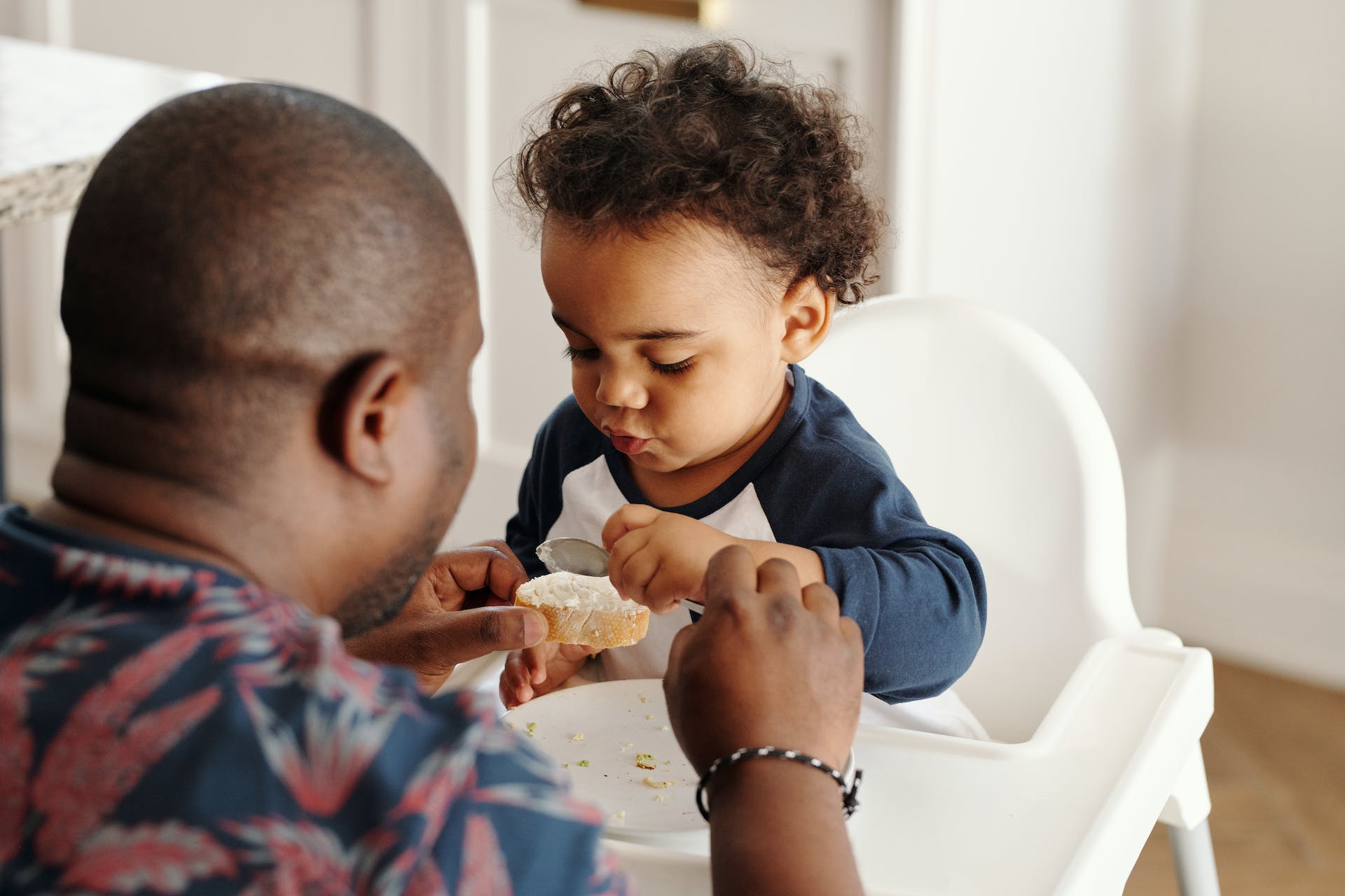 man feeding baby