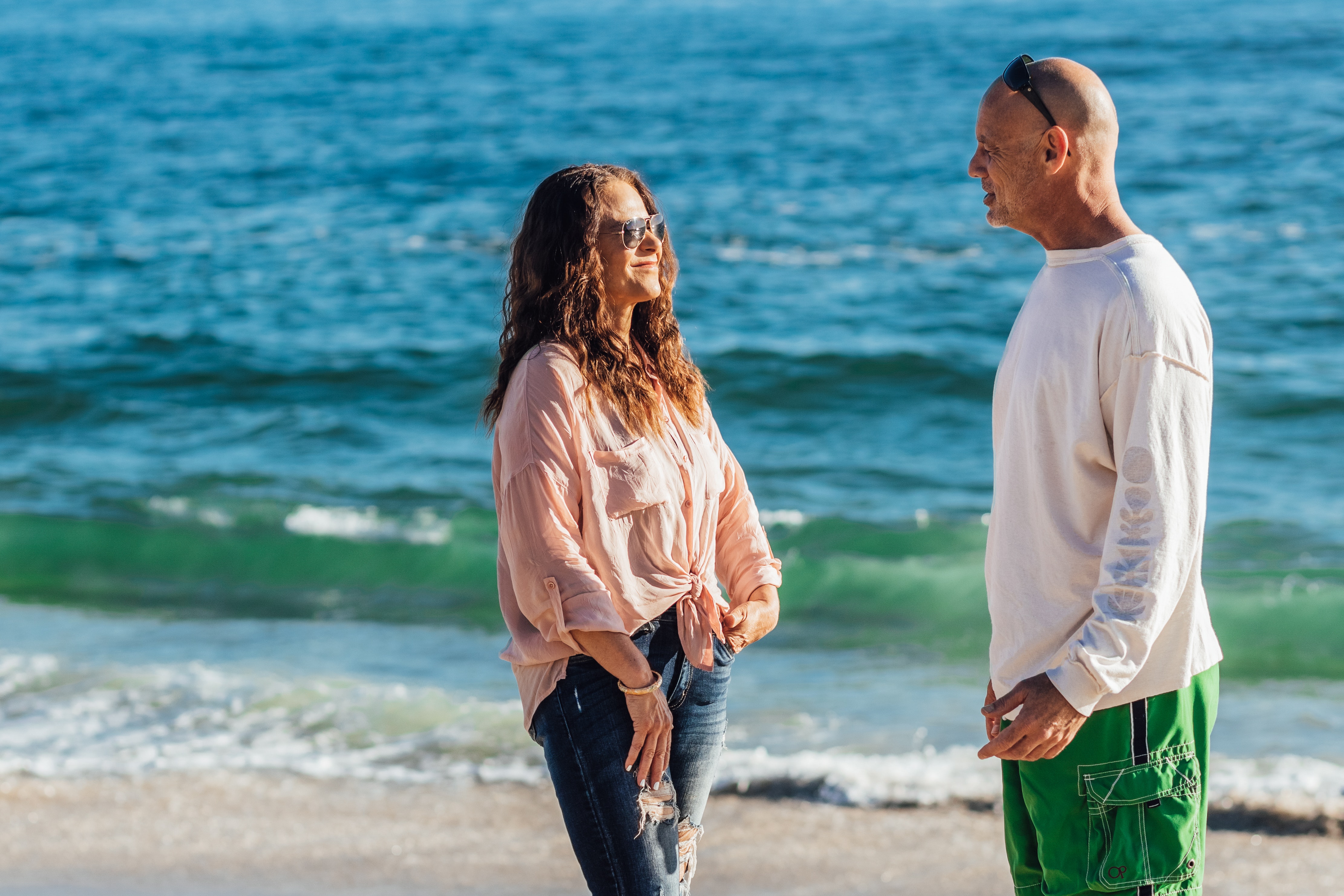 A couple talking on a beach