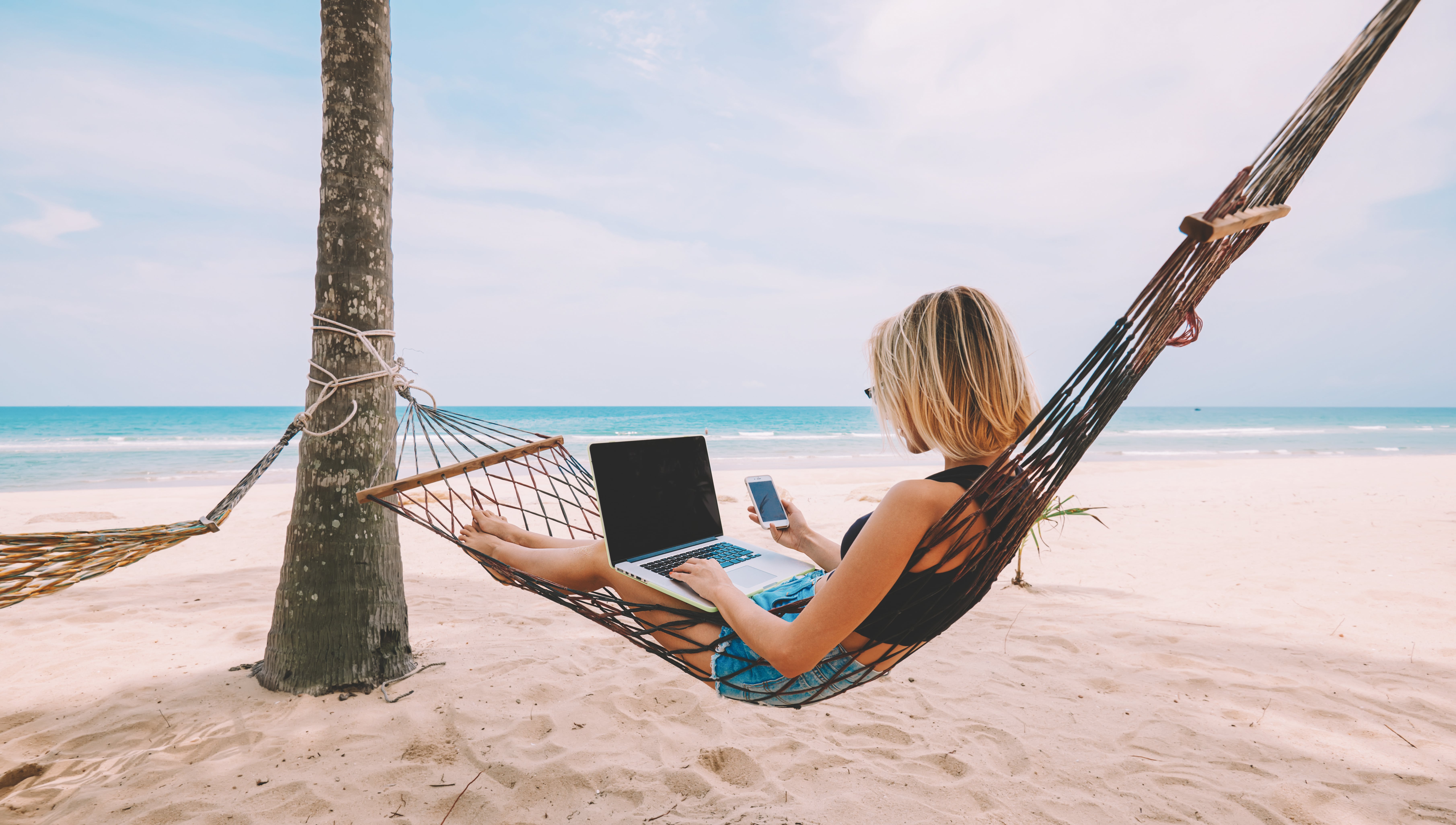 Woman working from the beach
