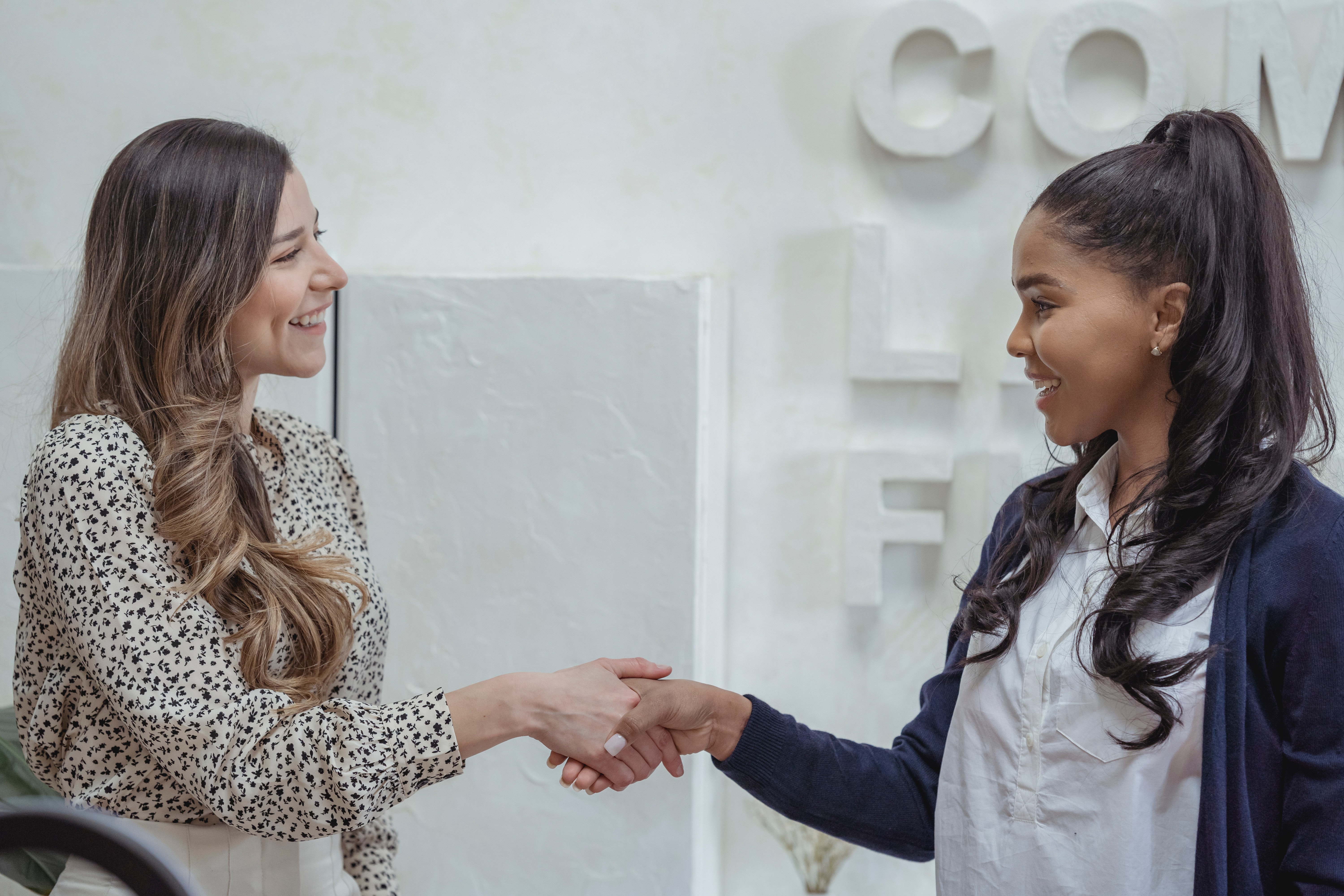 Two woman shaking hands