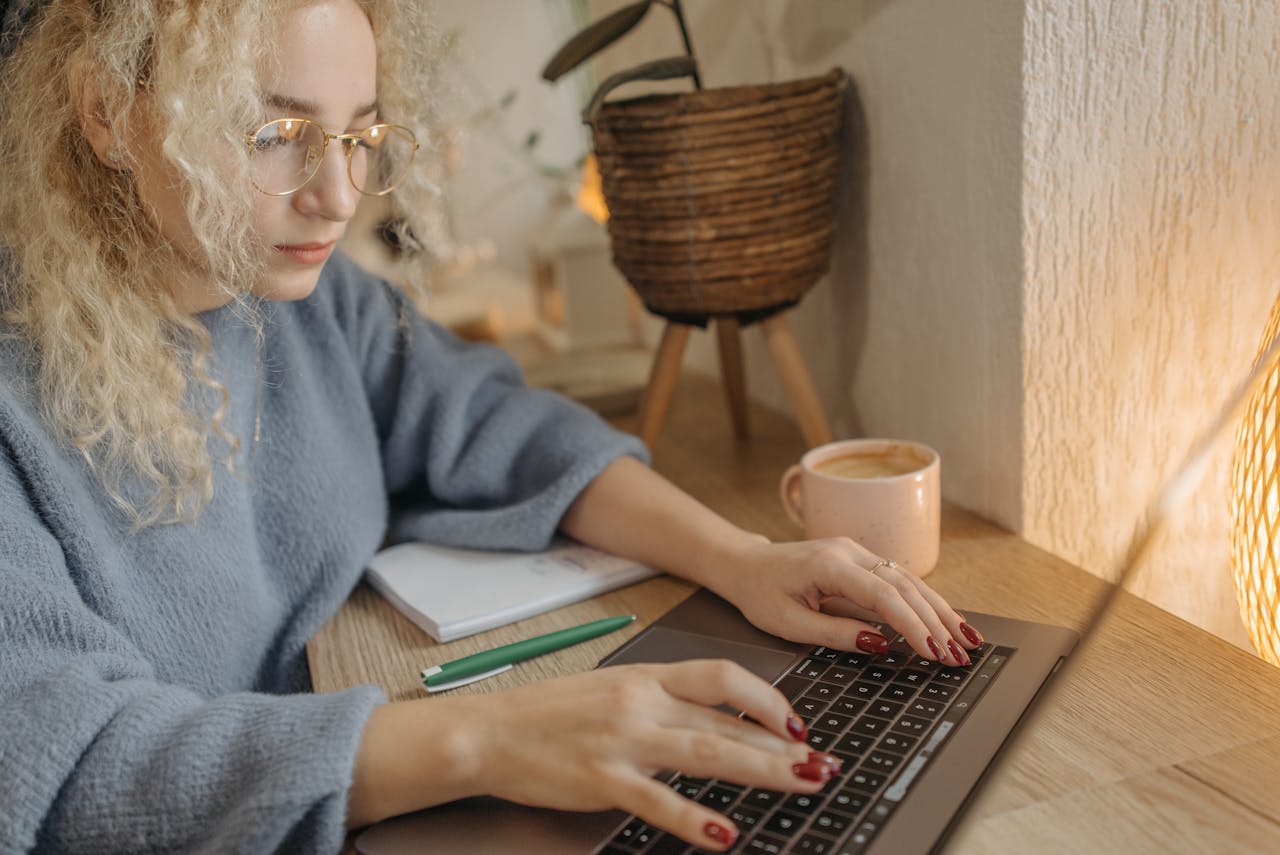 Close-Up Shot of a woman Using a Laptop