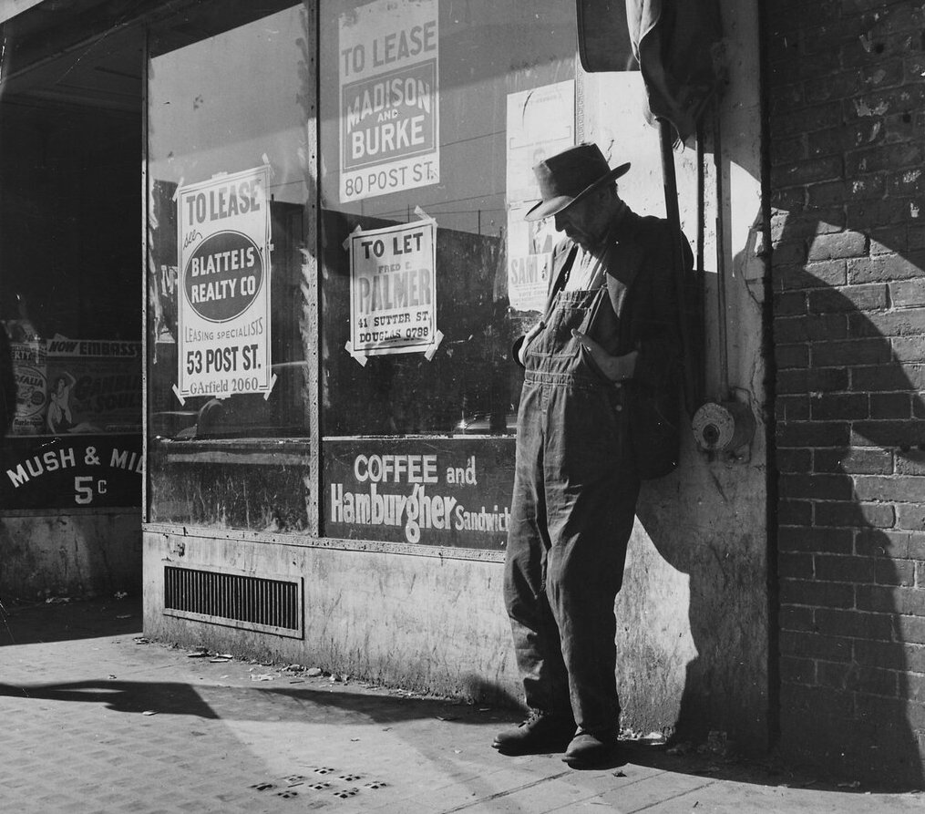 Unemployed;destitute man leaning against vacant store