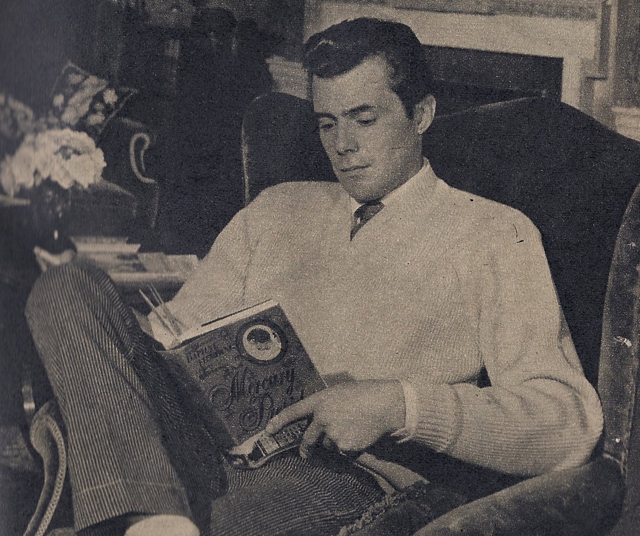 Dirk Bogarde reading a book