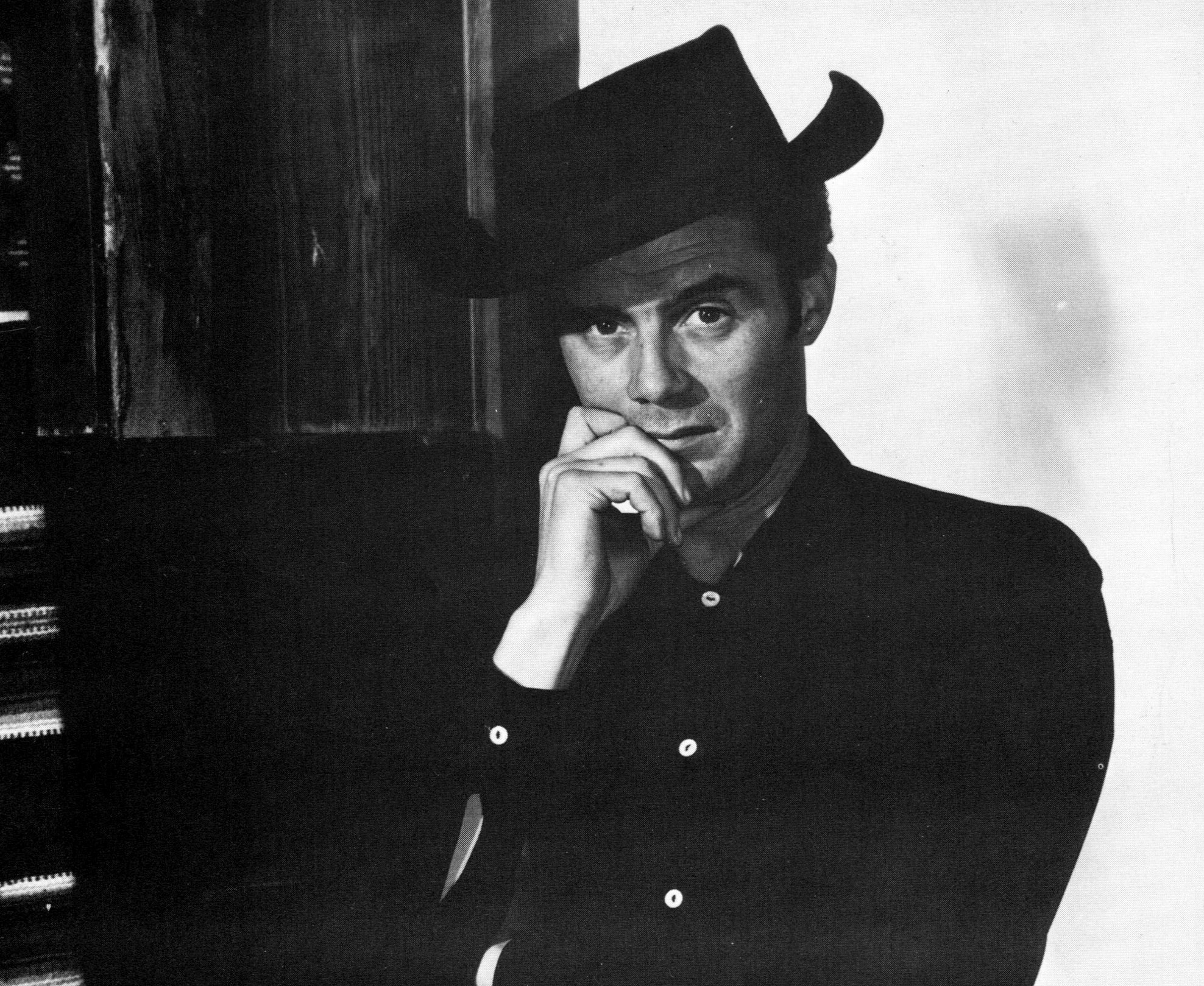 Dirk Bogarde posing for a photo