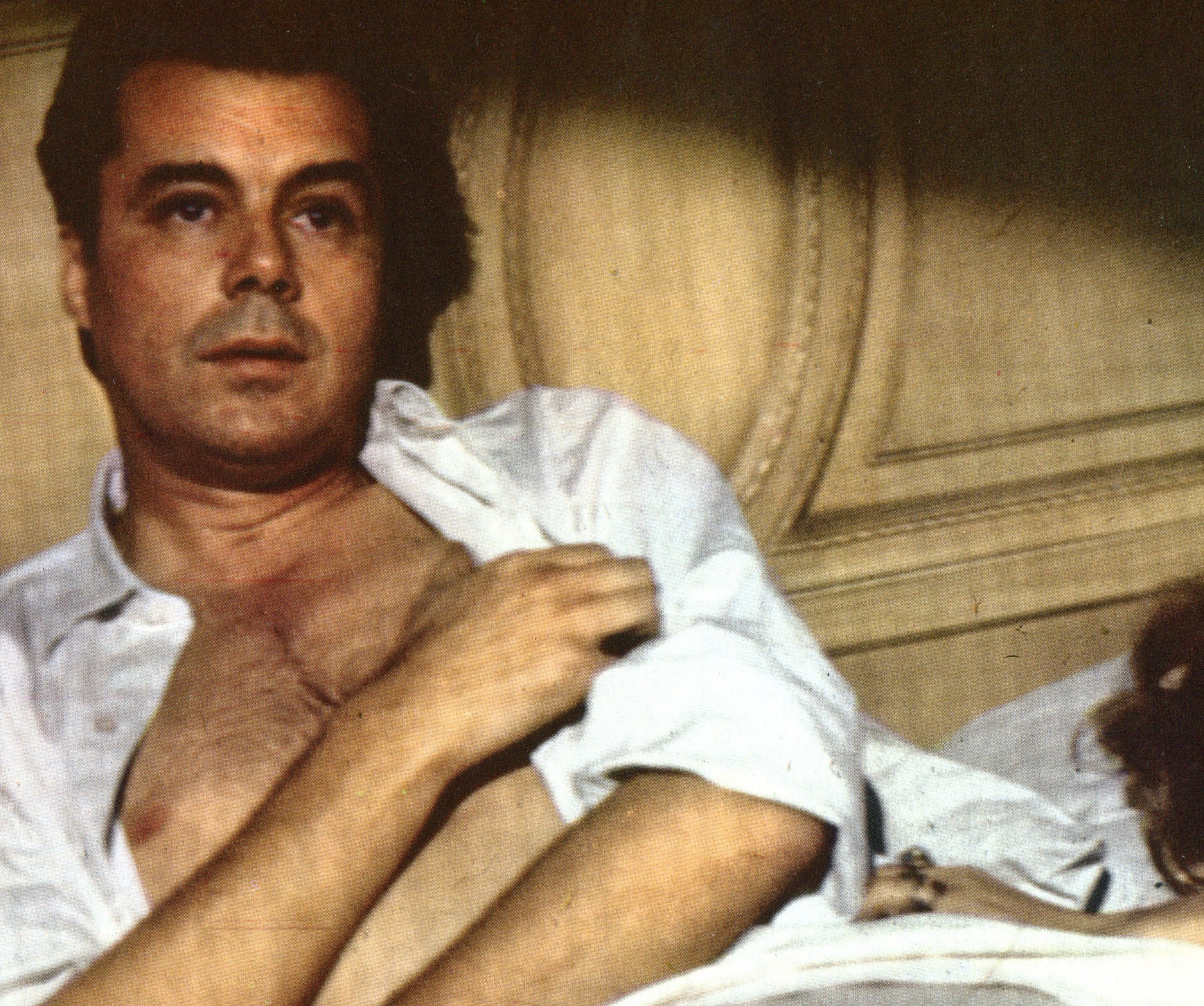 Dirk Bogarde laying on a bad