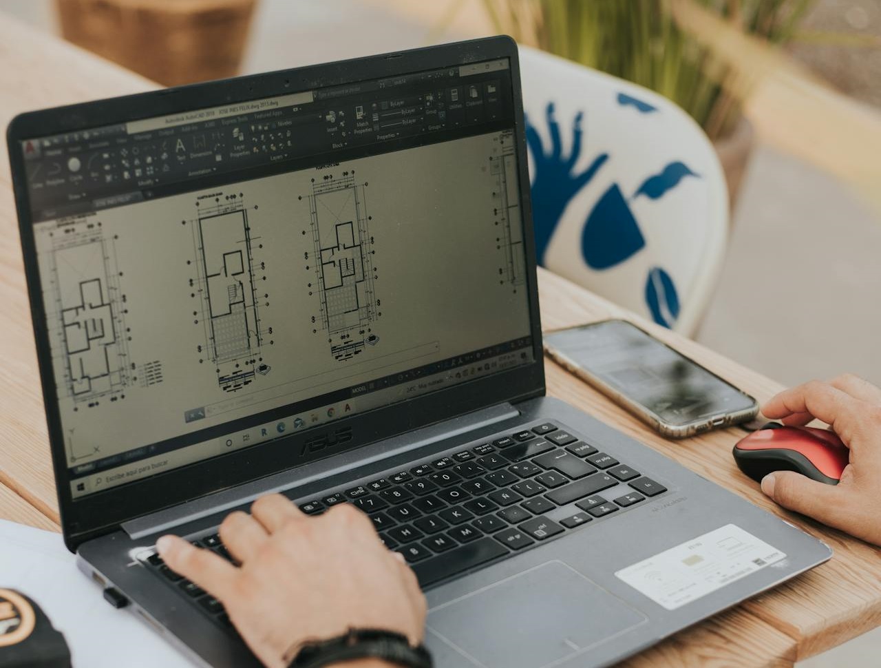 Man drawing in CAD at PC.