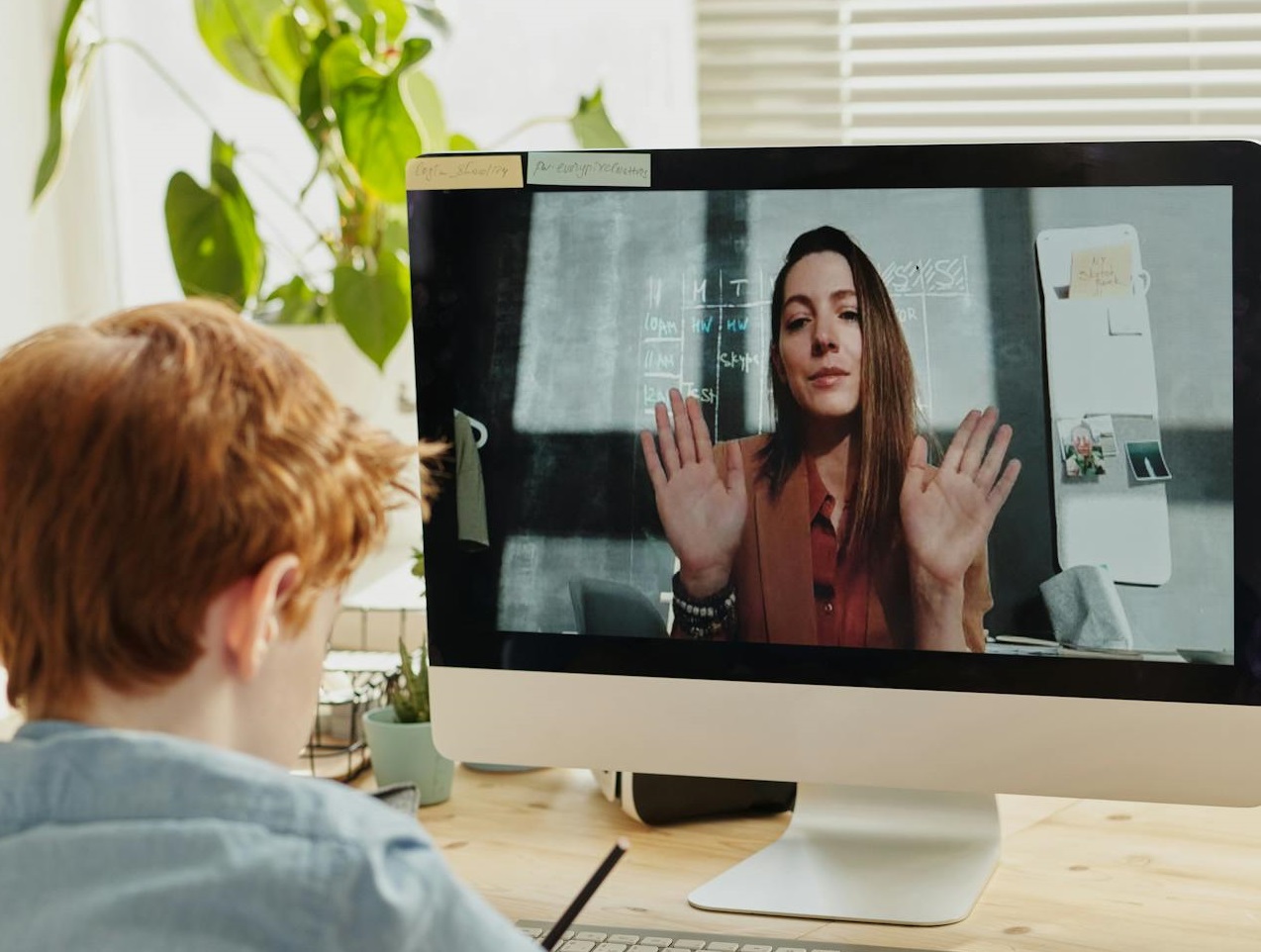 Photo of Boy Video Calling With a Woman
