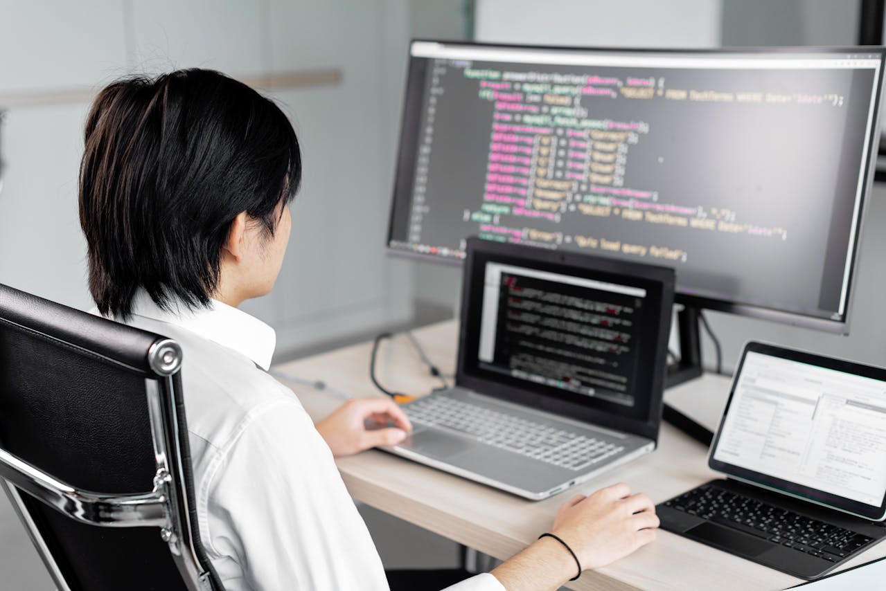 A Man Sitting in Front of the Computer while Working