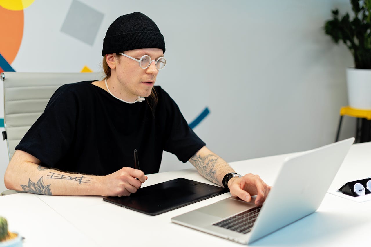 A Man using laptop and digital drawing board