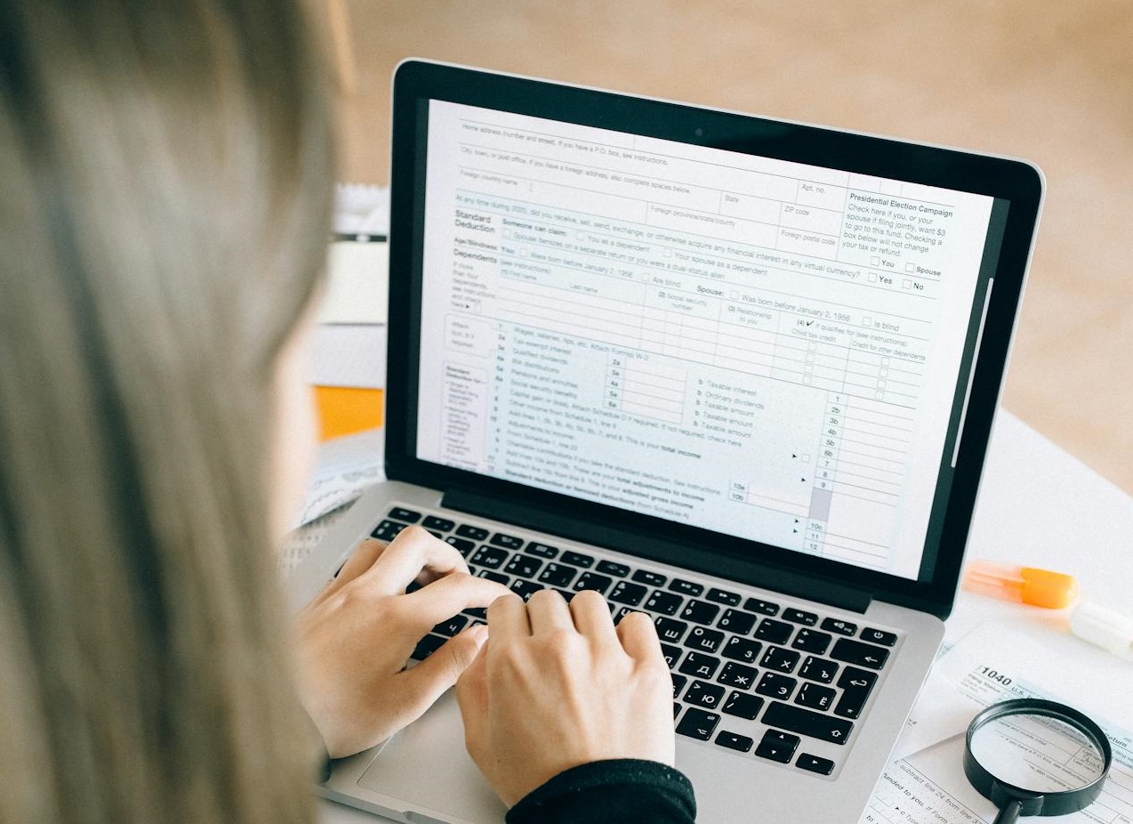 Woman entering data on Laptop