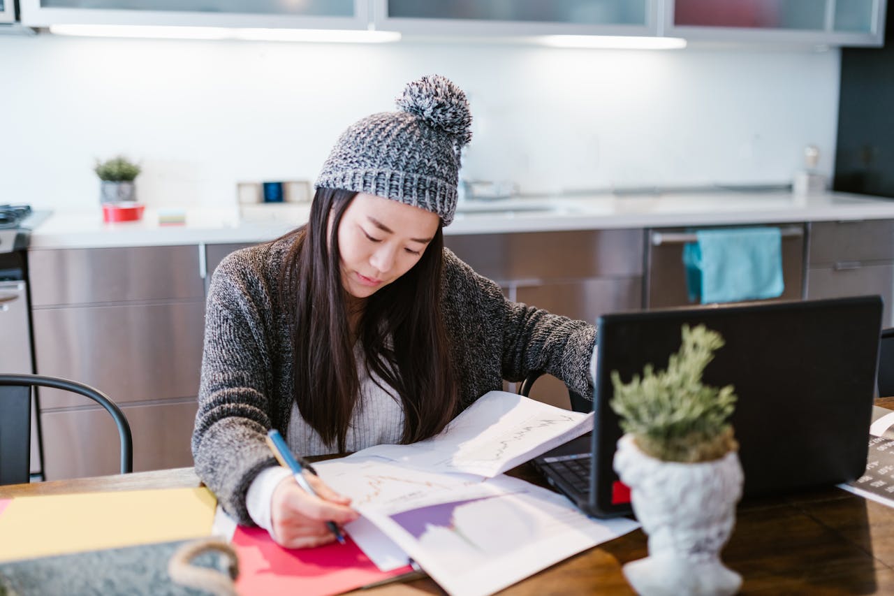 Woman Working with Statistical Data at Home
