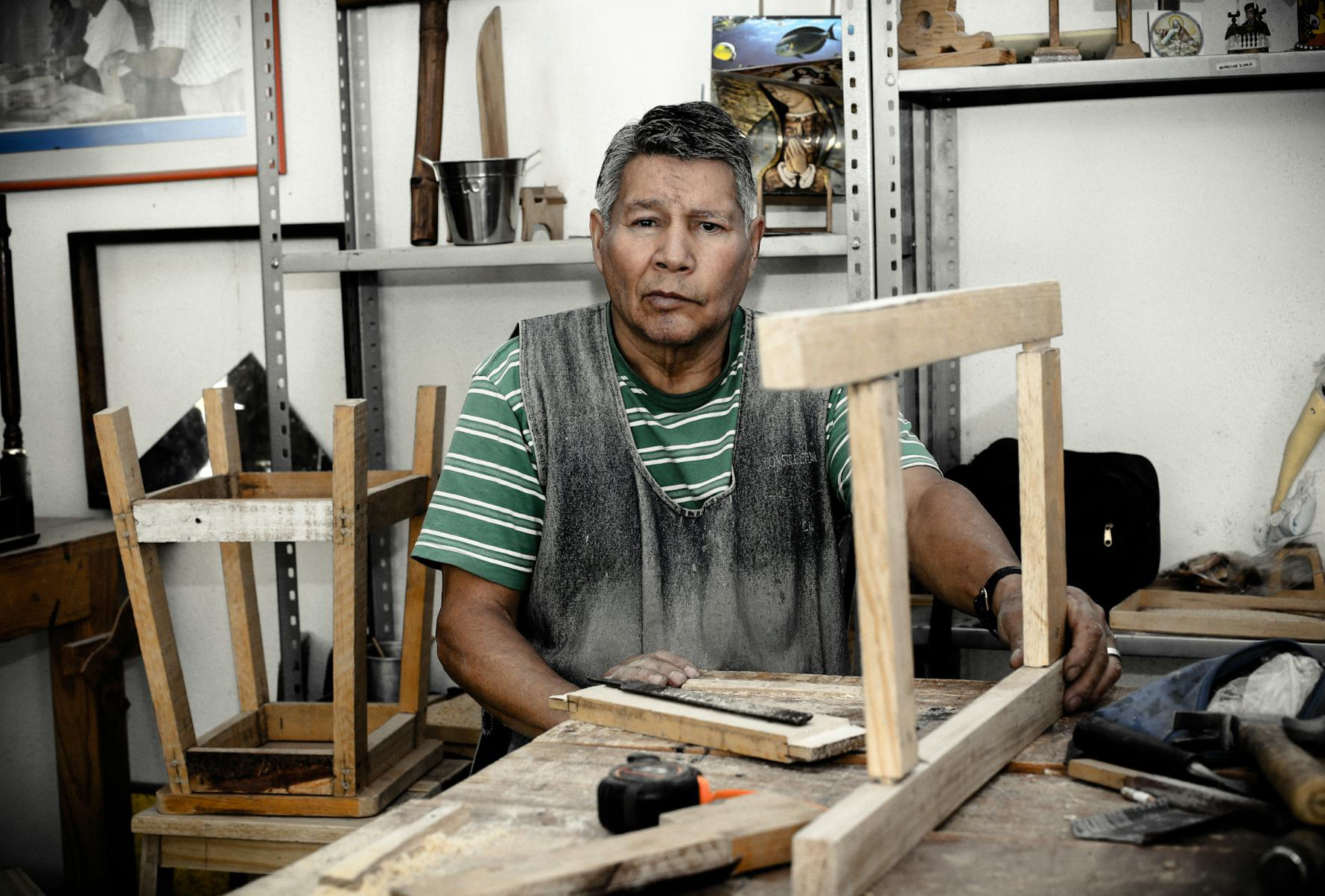 A carpenter working on a wooden frame