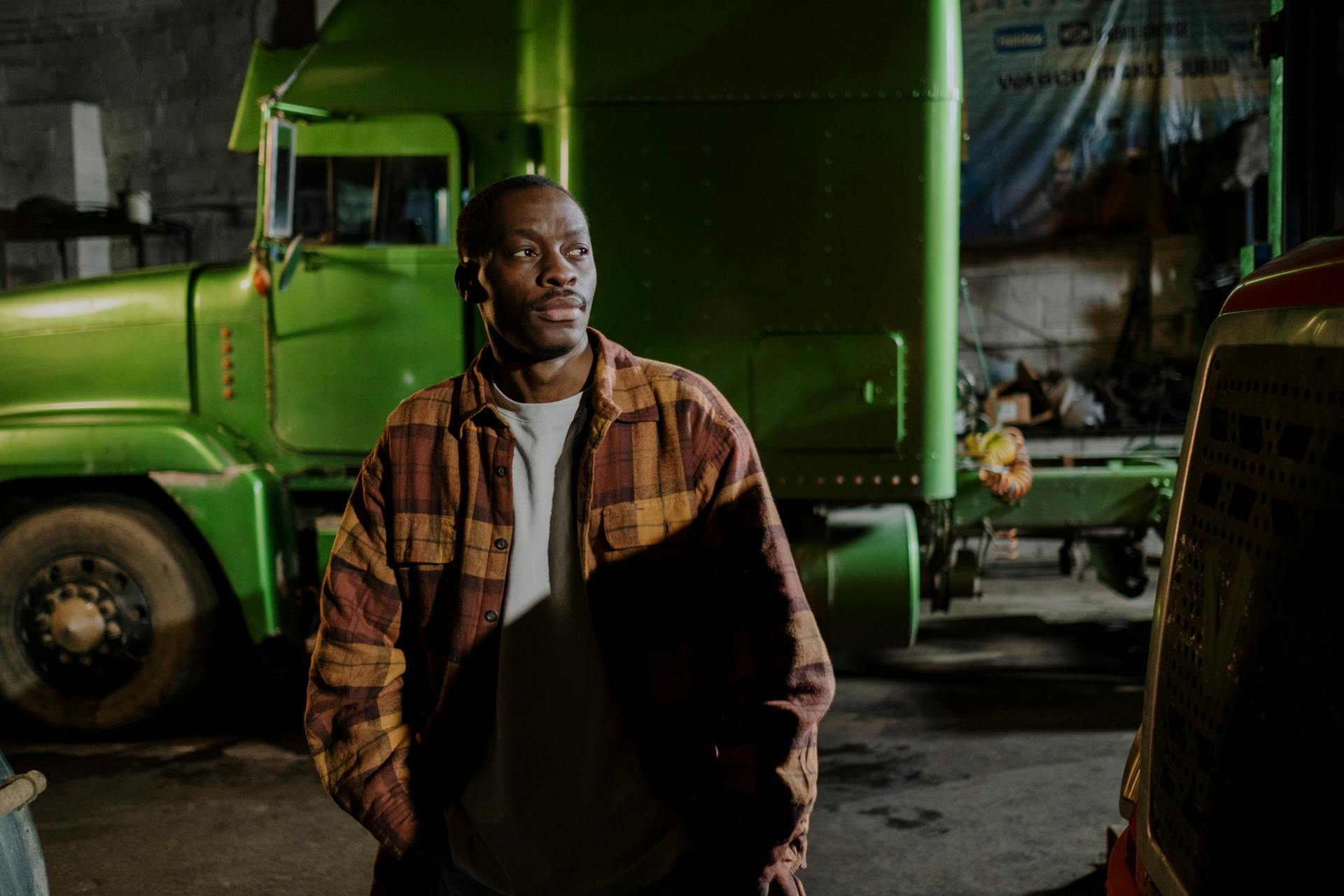 Man Standing Near A Green Truck