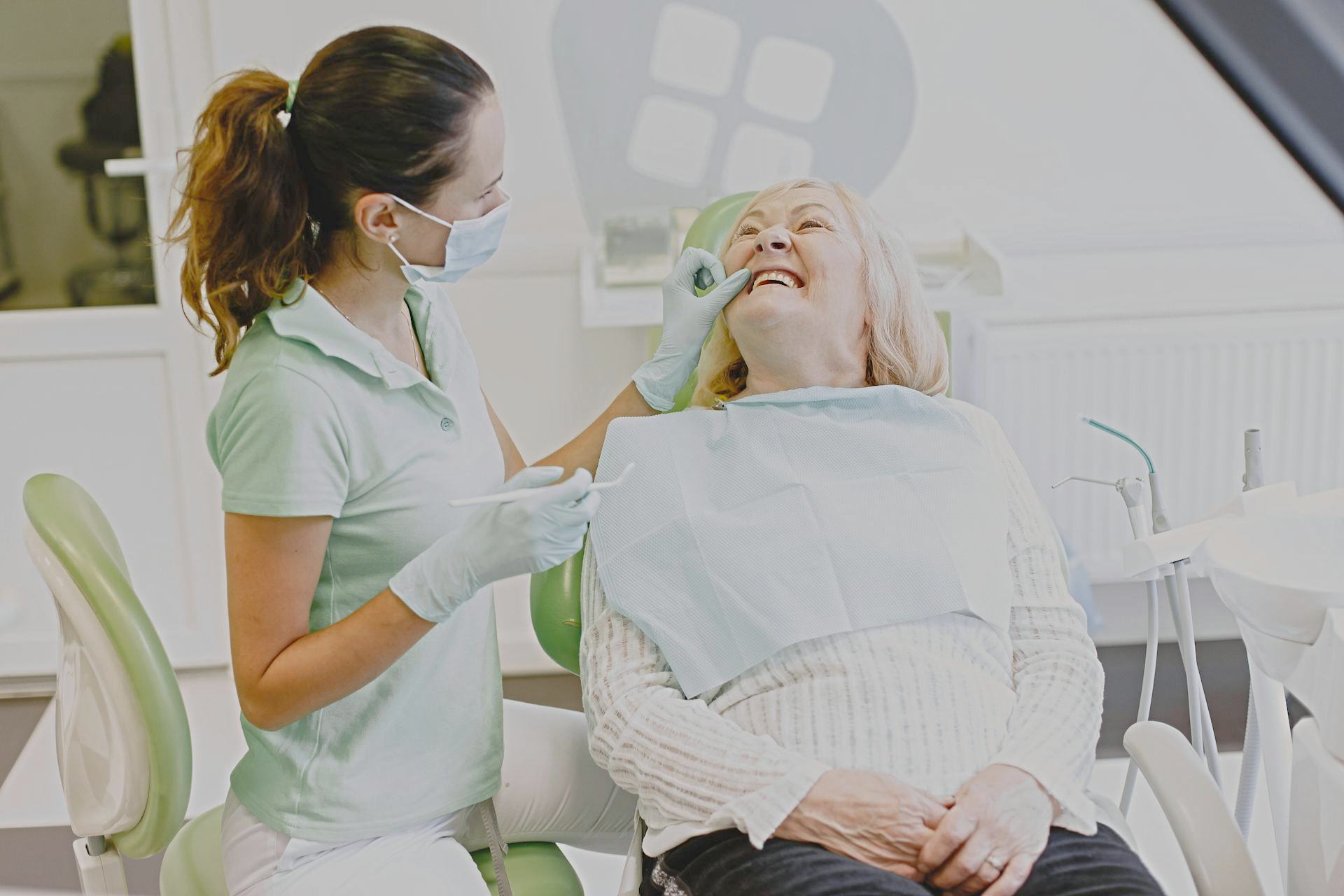 A dental hygienist with a patient
