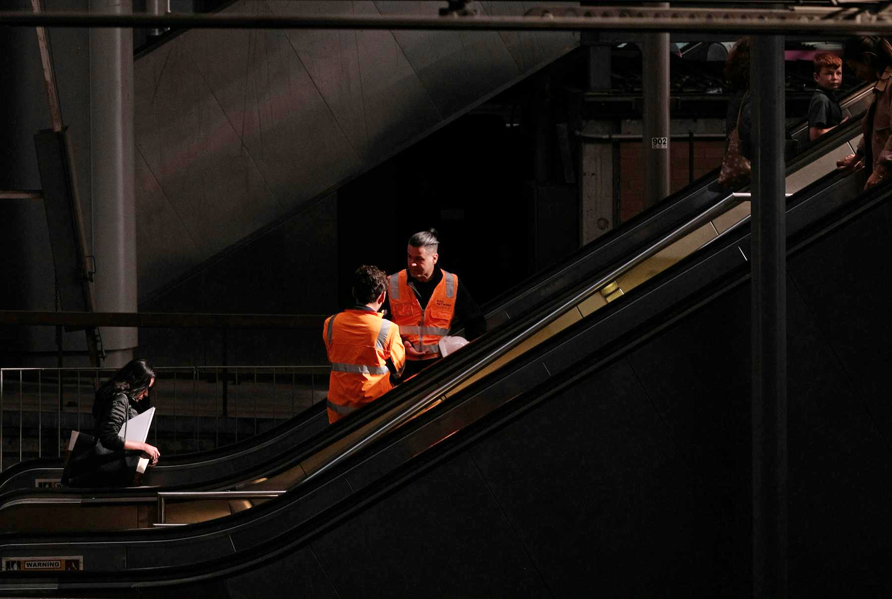 Men in Reflective Vests Standing in Industrial Hall