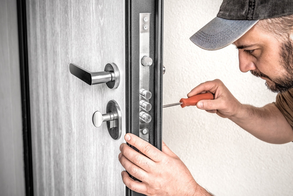 Professional locksmith repairing a door
