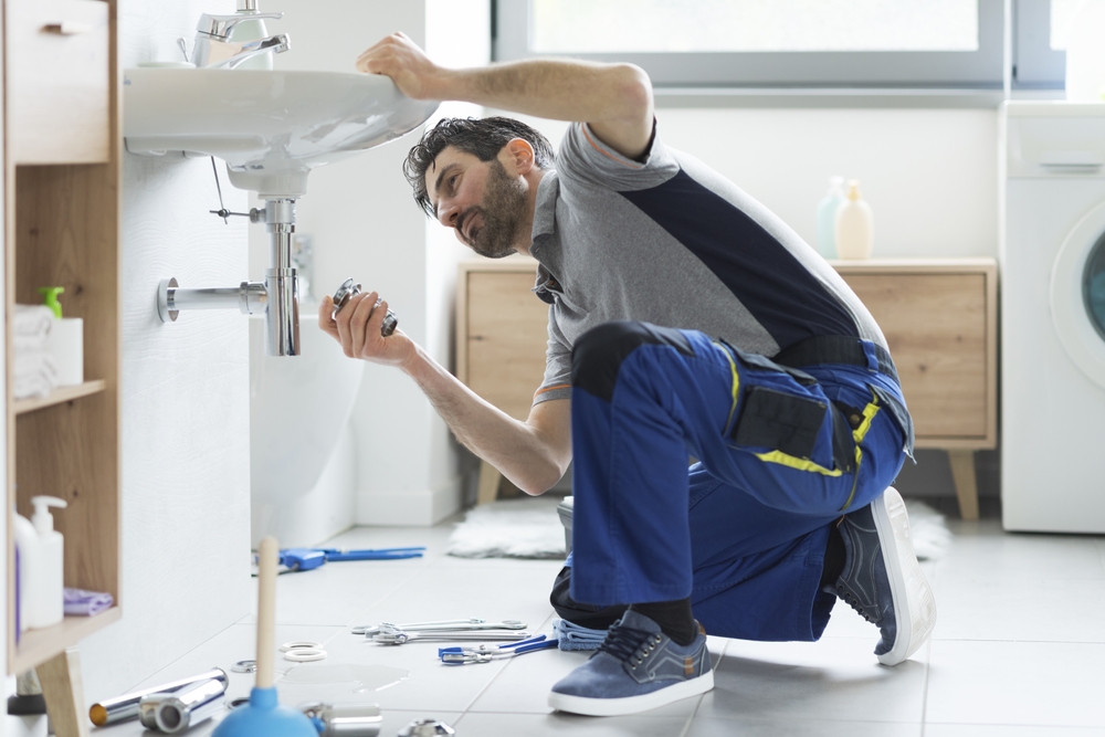 Plumber repairing a bathroom sink