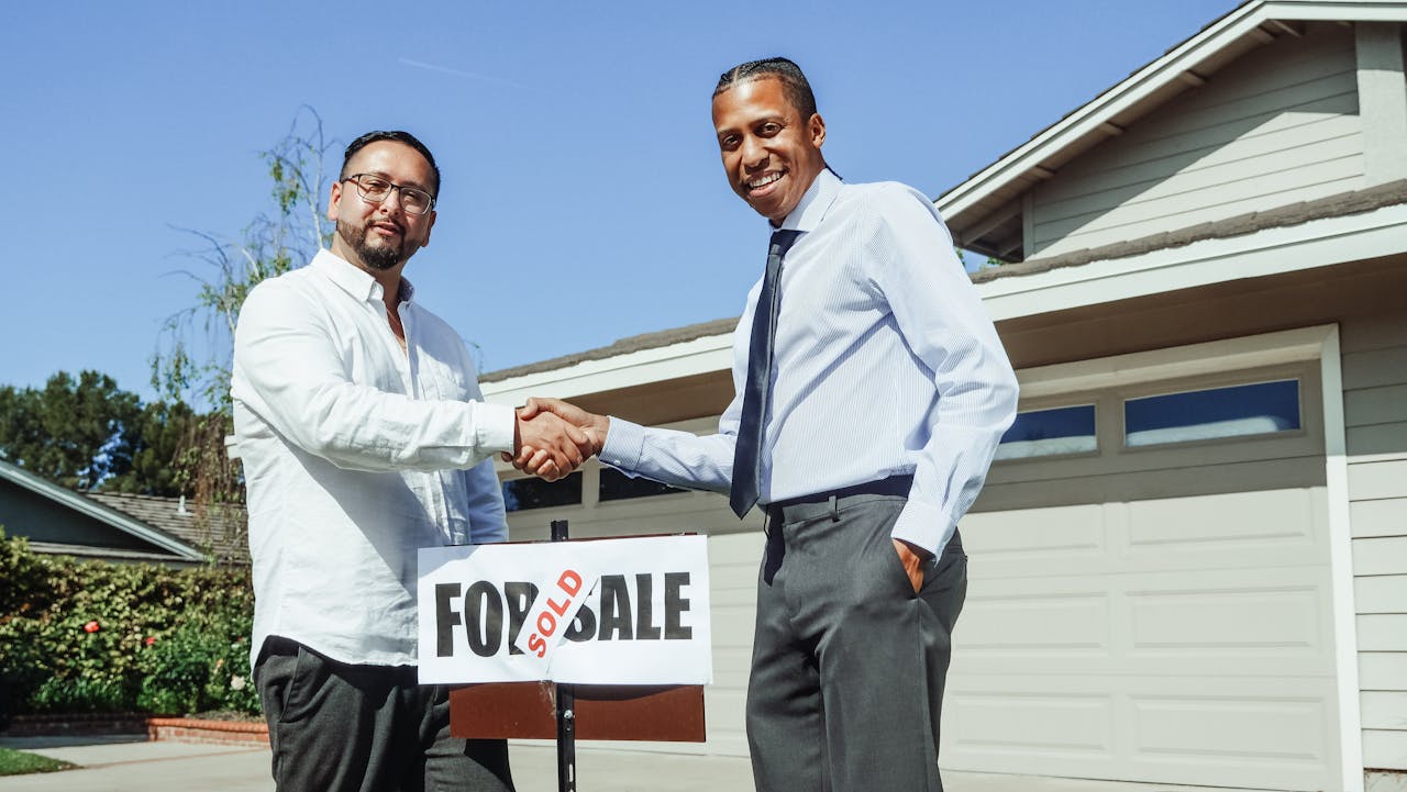 Men Shaking Hands - Sold house.