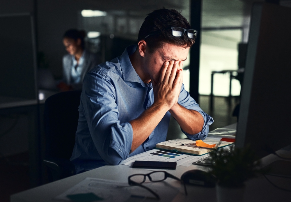 Portrait Photo of Man stressed in office at night