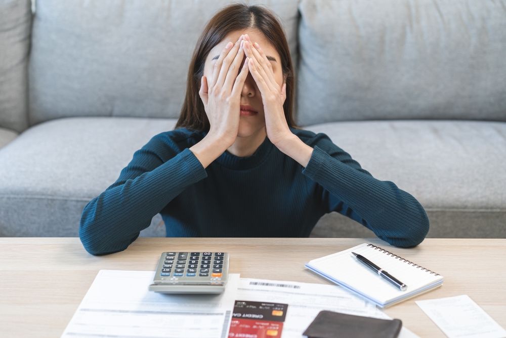 Stressed Woman sitting with covered face with hands