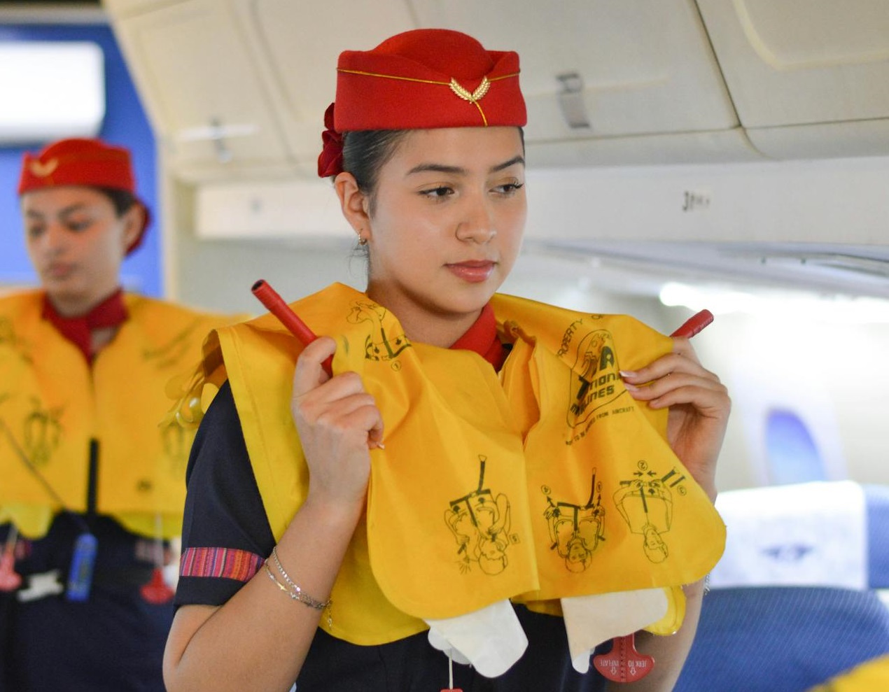 Flight Attendant Demonstrating Emergency Procedures in a Plane