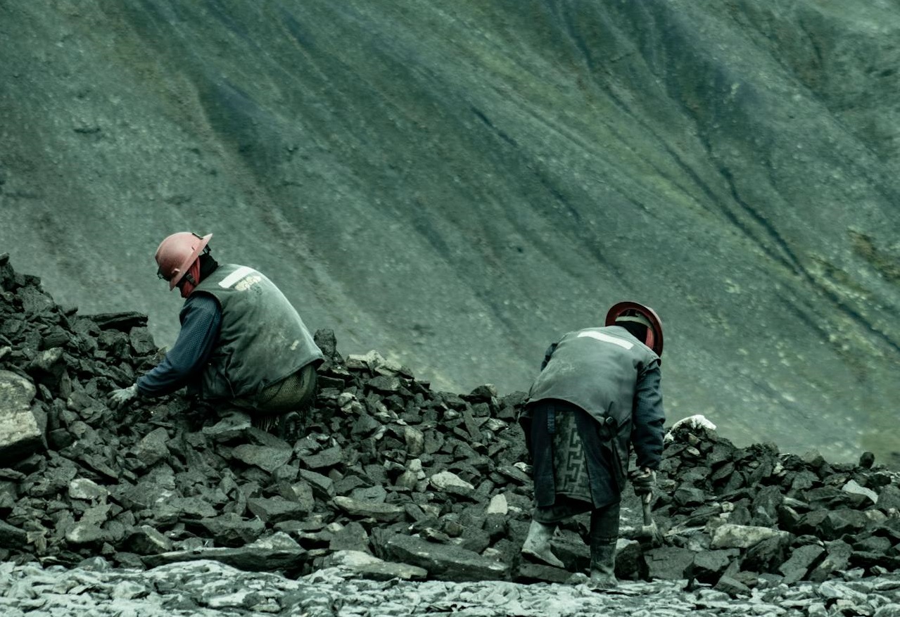 Miners Digging Through a Pile of Stones