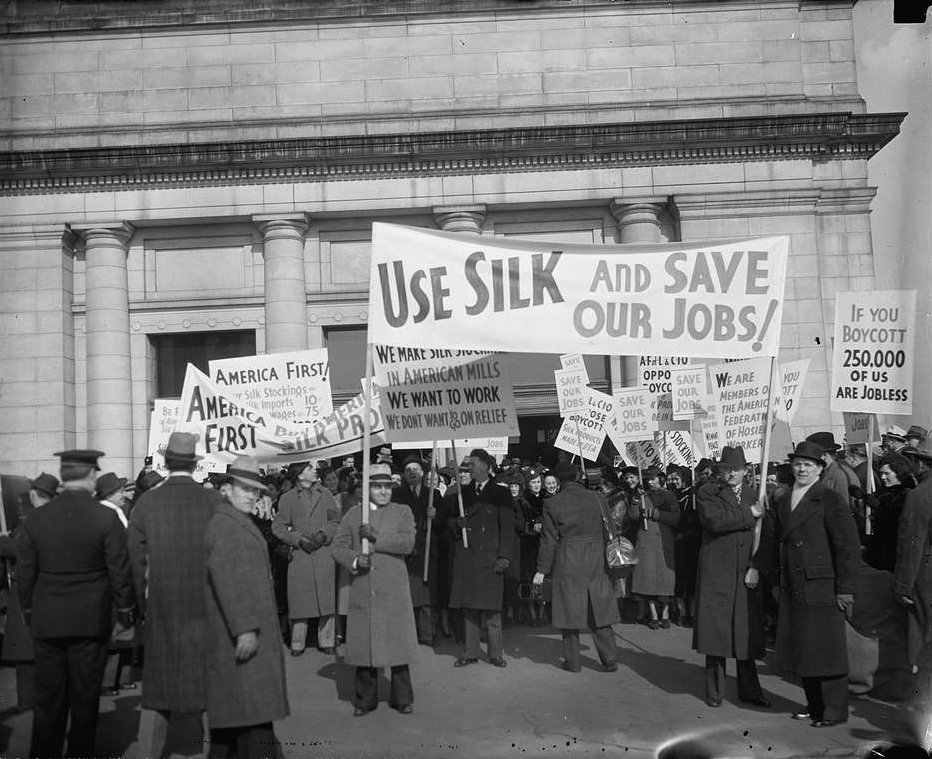 A group of people holding signs in front of a building, Library of Congress Harris and Ewing collection