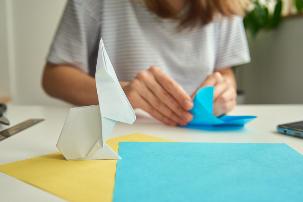 Woman making origami rabbit