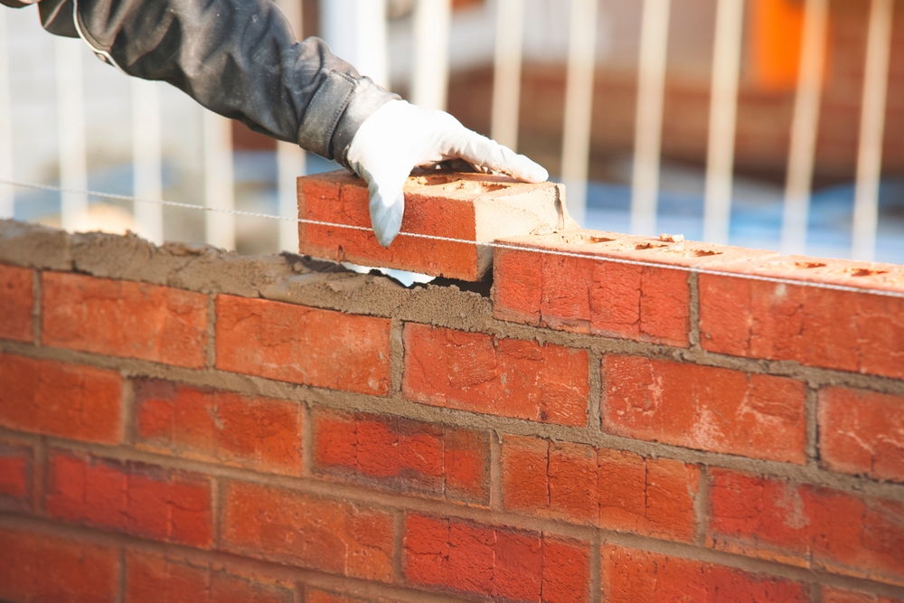 Bricklayer laying bricks.