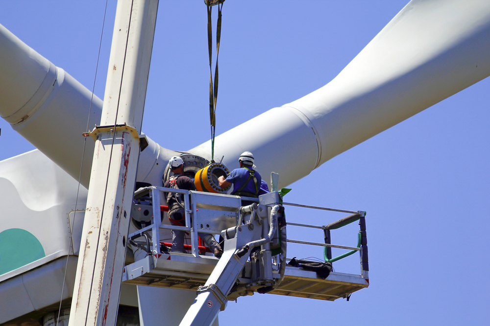 Wind turbine being repaired, manual workers maintenance