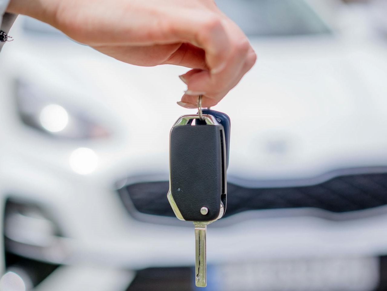 Person Holding a Car Key