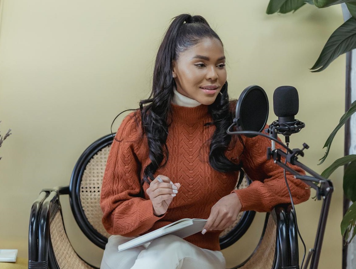 Female podcaster speaking into microphone