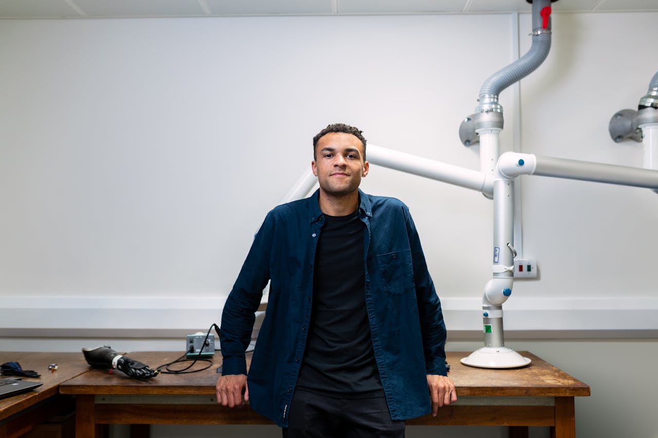 Man Standing Beside Brown Wooden Table