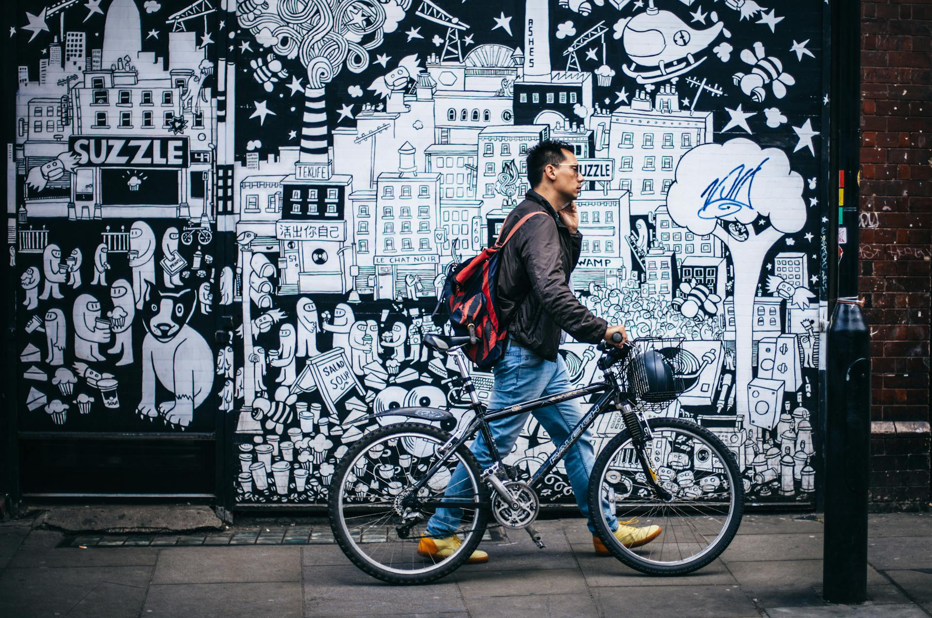 Man in Black Jacket Holding a Black Hardtail Bike
