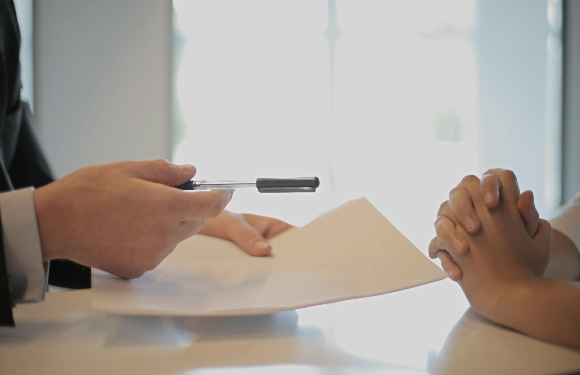 Businessman giving contract to woman to sign