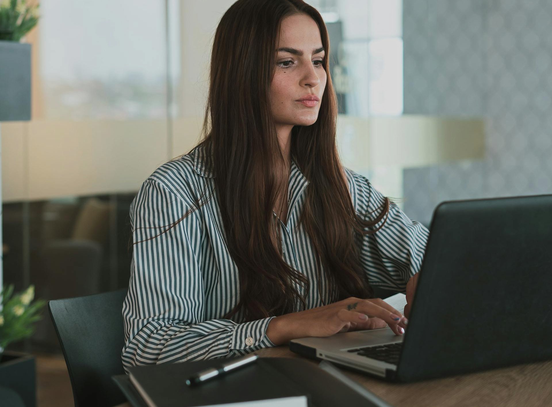 Portrait of Brown Haired Woman Working on Laptop
