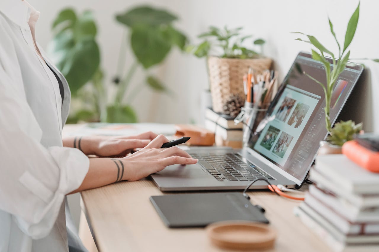 Woman working retouching photo on laptop