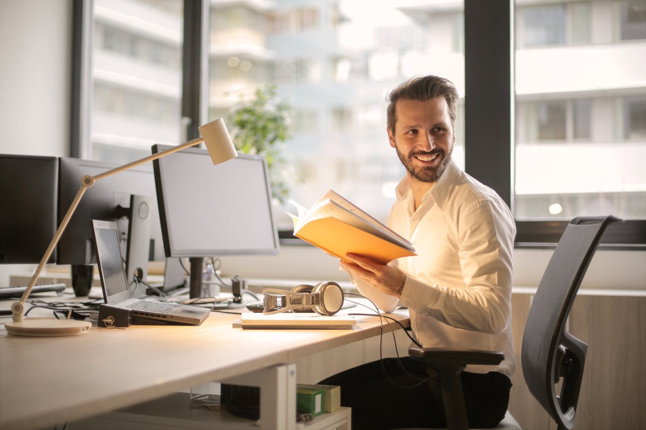 Photo of Man Sitting on a Desk