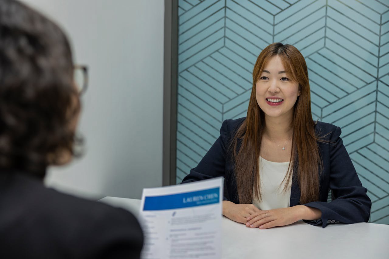 Confident woman in suit is smiling during job interview