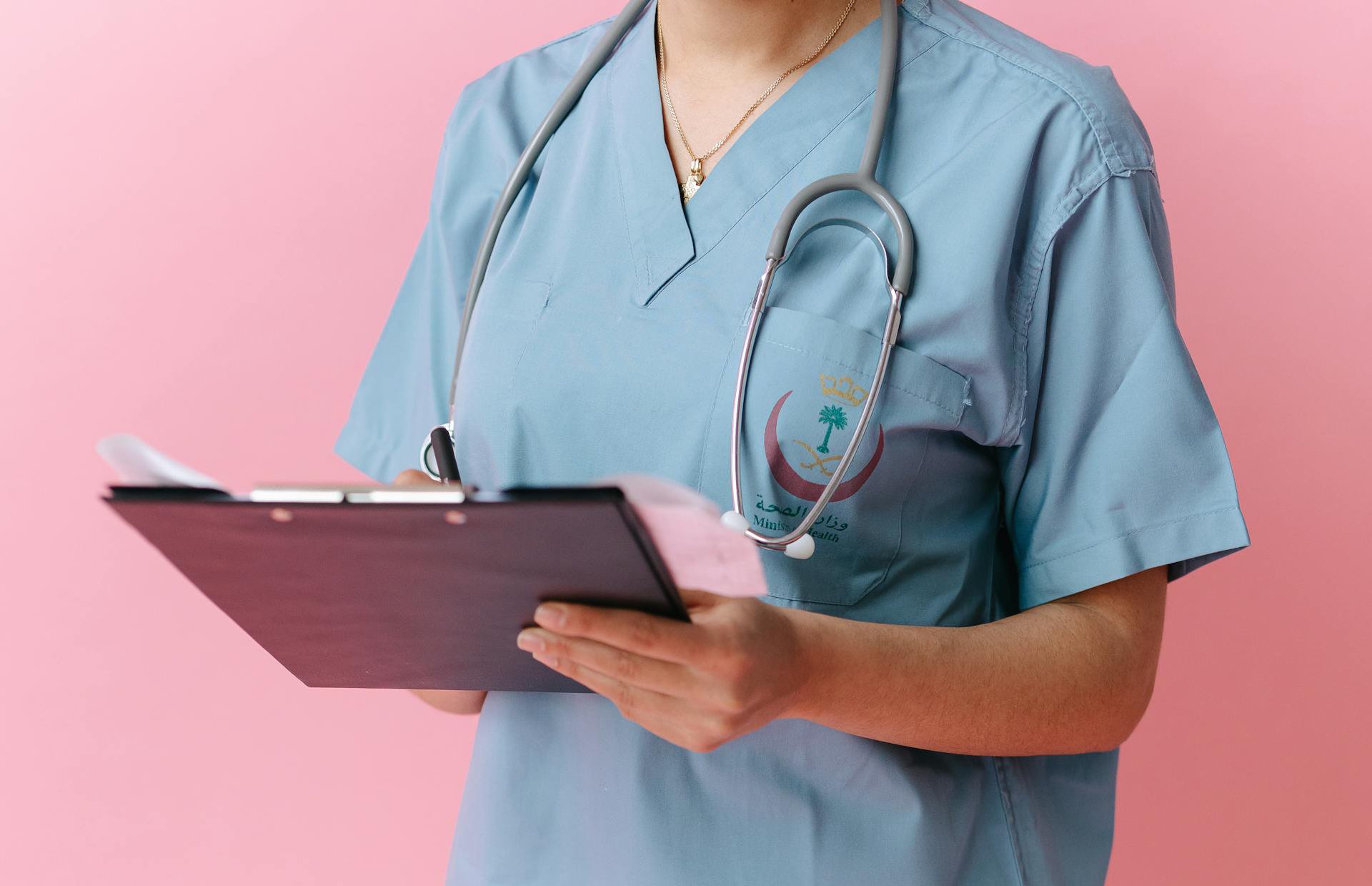 A Close-Up Shot of a Nurse Holding a Clipboard
