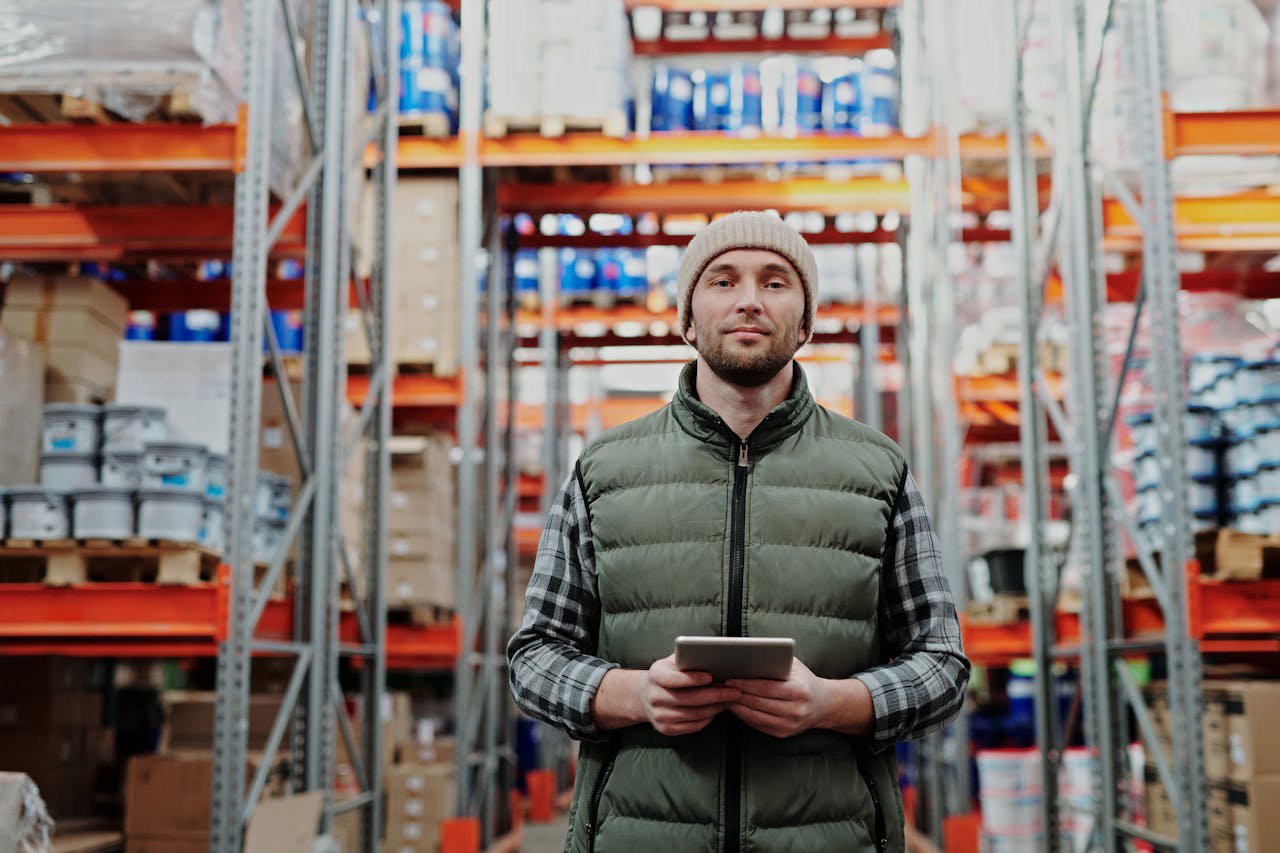 Man in Bubble Jacket Holding Tablet Computer