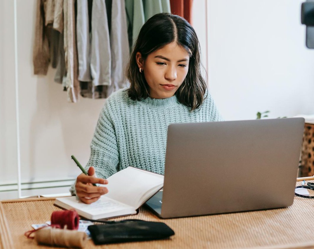 Portrait Photo of Focused blogger working on project at home