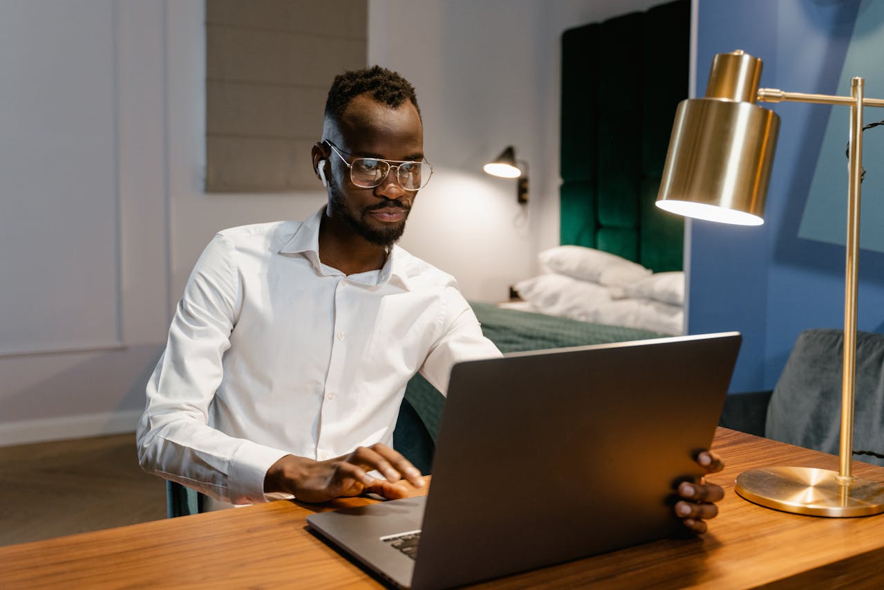 Portrait Photo of A Man Using Laptop at Home