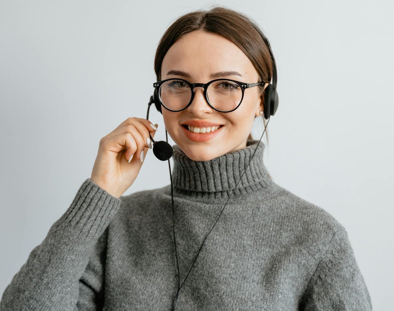 Portrait Photo of a Young Woman with Black Headset and Mouthpiece