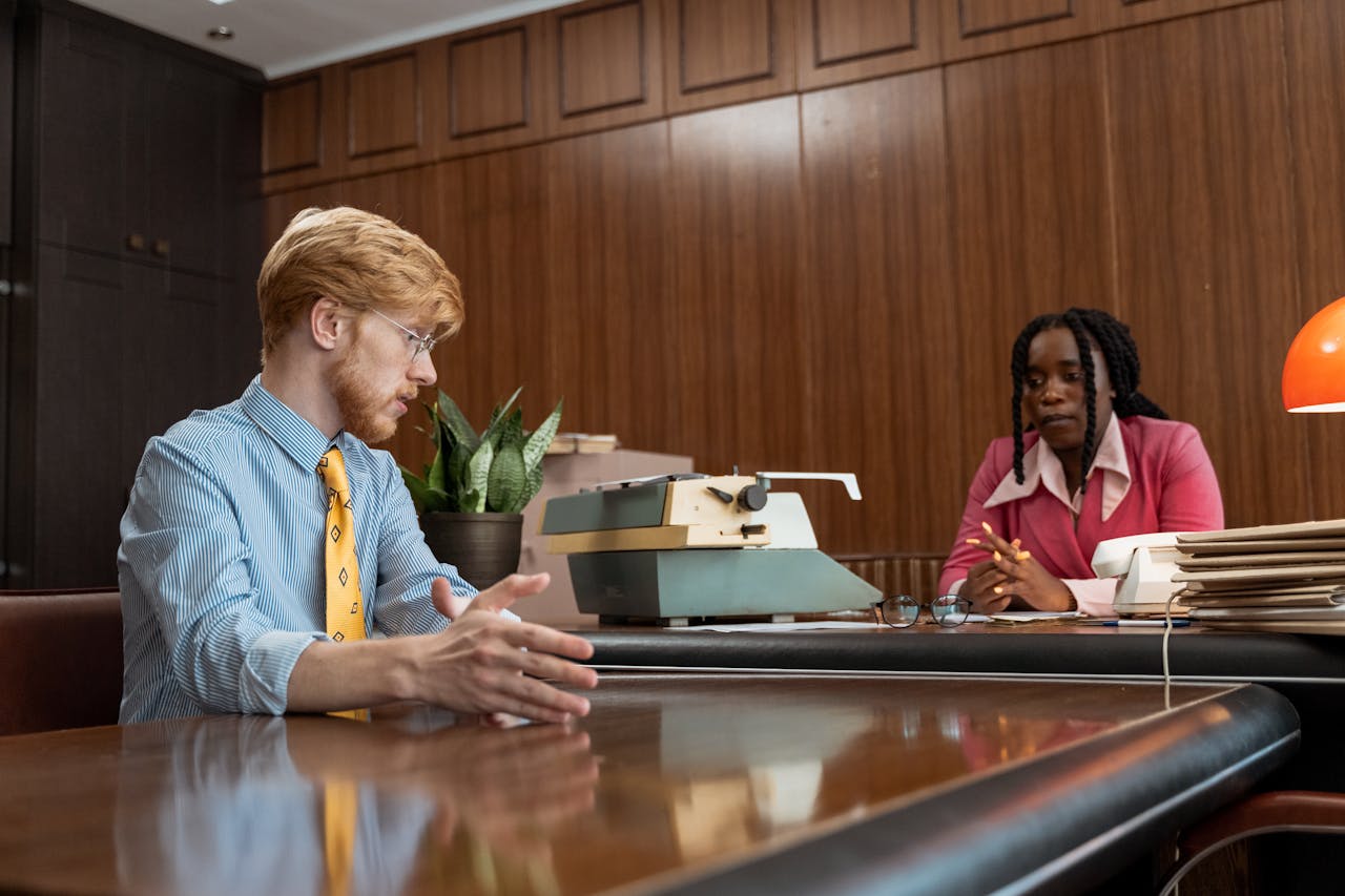 An Employee Talking to His Boss in Office