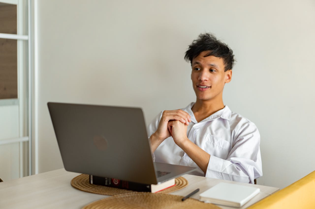 Portrait Photo of A Young Man using a Laptop At home